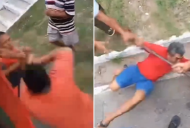 Homens brigando em uma calçada