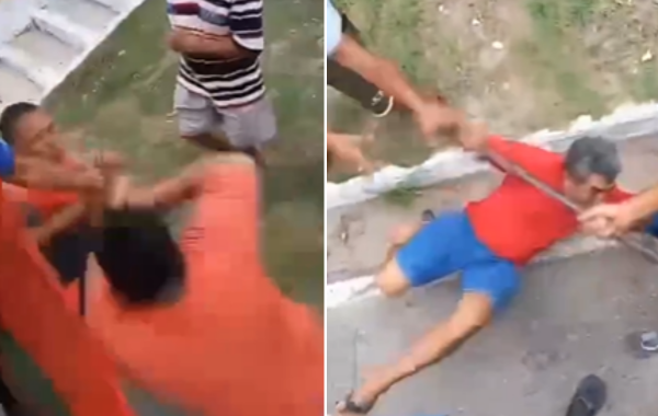 Homens brigando em uma calçada