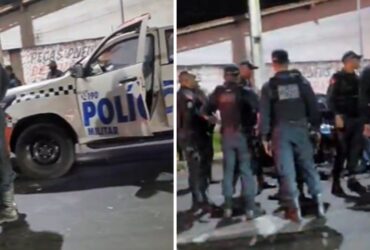 Viatura da polícia e policias de roupa azul-marinho