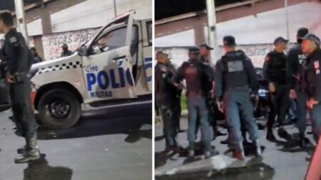 Viatura da polícia e policias de roupa azul-marinho