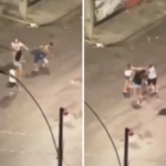 Homens brigando no meio de uma via