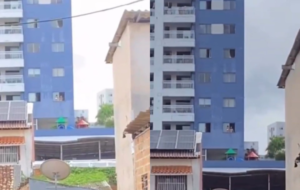 Imagem da lateral do prédio com a criança na janela