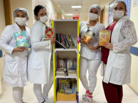 Funcionárias do hospital com a "Biblioteca Itinerante"