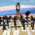 Na praia, cruzes aparencem enterradas na areia em sinal de protesto pela morte de passoas trans
