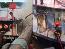 Homens do Corpo de Bombeiros atuam no combate a incêndio em embarcação.